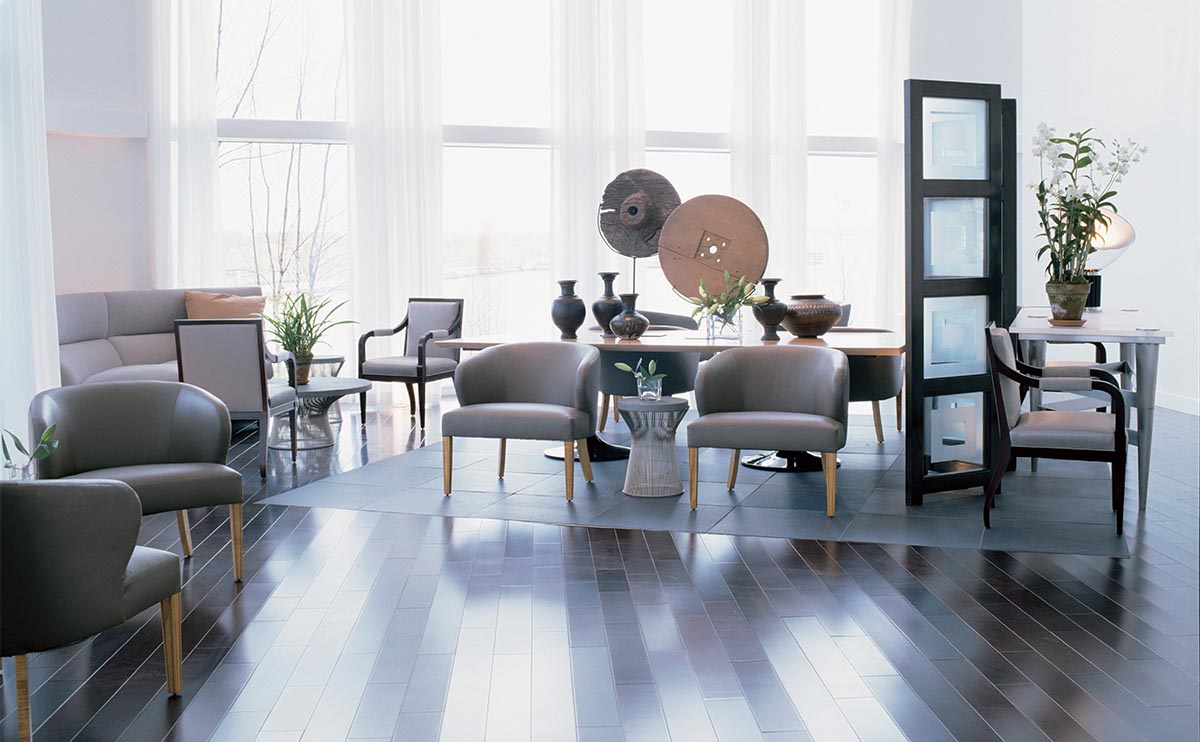 Clay tones, furniture, and a stone floor insert demarcate an intimate space.